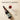 Wine bottle with a glass of red wine and a note on a textured surface, with text 'Hand-picked. No algorithms.'